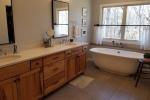 Master bathroom with a tub and tile work