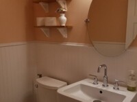 A guest bathroom sink with silver hardware accents.