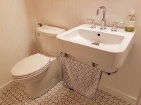 A guest bathroom sink with silver hardware accents.