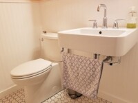 A guest bathroom sink with silver hardware accents.