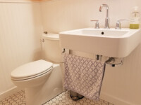 A guest bathroom sink with silver hardware accents.