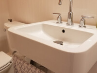A guest bathroom sink with silver hardware accents.