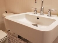 A guest bathroom sink with silver hardware accents.