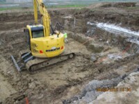 Excavator outside Bowling Green Prison for plumbing work