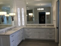A master bathroom with chandelier lighting and an angled countertop.