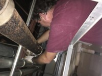Heggemann Inc. technician working on plumbing pipes