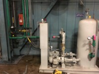 Room with a maze of plumbing pipes and ducts