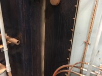 Plumbing distribution room with a tangle of pipes and gauges